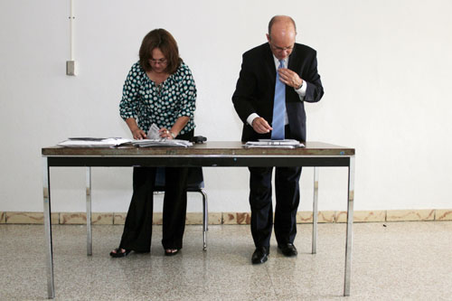 Millie Fornell, left, and John Doyle, both Miami Dade County Public Schools officials, count student voter registration applications at Southwest Miami High School on May 30, 2012, as part of a district-wide registration drive. Photo by Ethan Magoc/News21