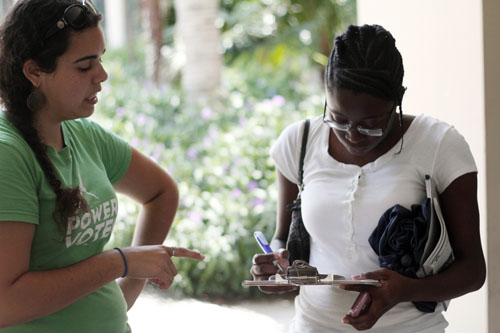 From left, Jacquie Ayala of Southern Energy Network, which organizes a third-party voter registration, talks with Christina Jean, 19, of Lake Worth, Fla., on the Florida Atlantic University campus on May 30, 2012. Jean registered to vote as part of Southern Energy Network's drive that day. Photo by Ethan Magoc/News21